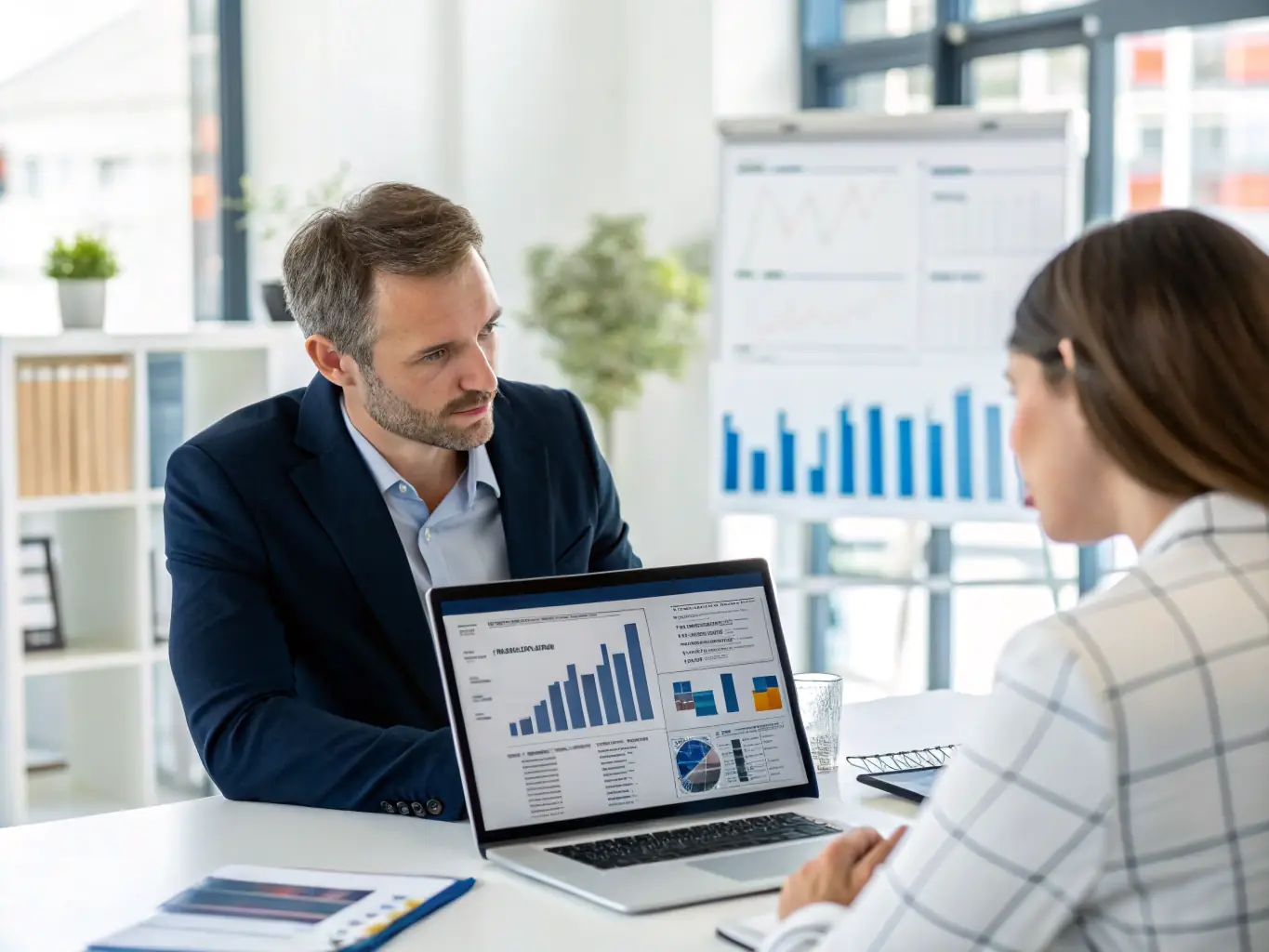 A professional Indian financial advisor discussing investment options with a client in a modern office setting, emphasizing trust and expertise.